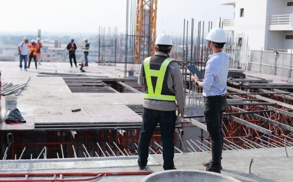 Engineers reviewing blueprints on site